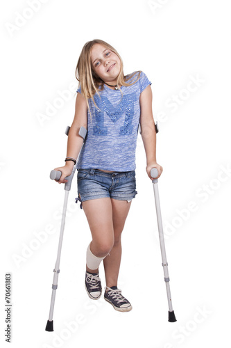 little girl with crutches isolated on white background