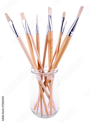 Paint brushes in glass jar isolated on white