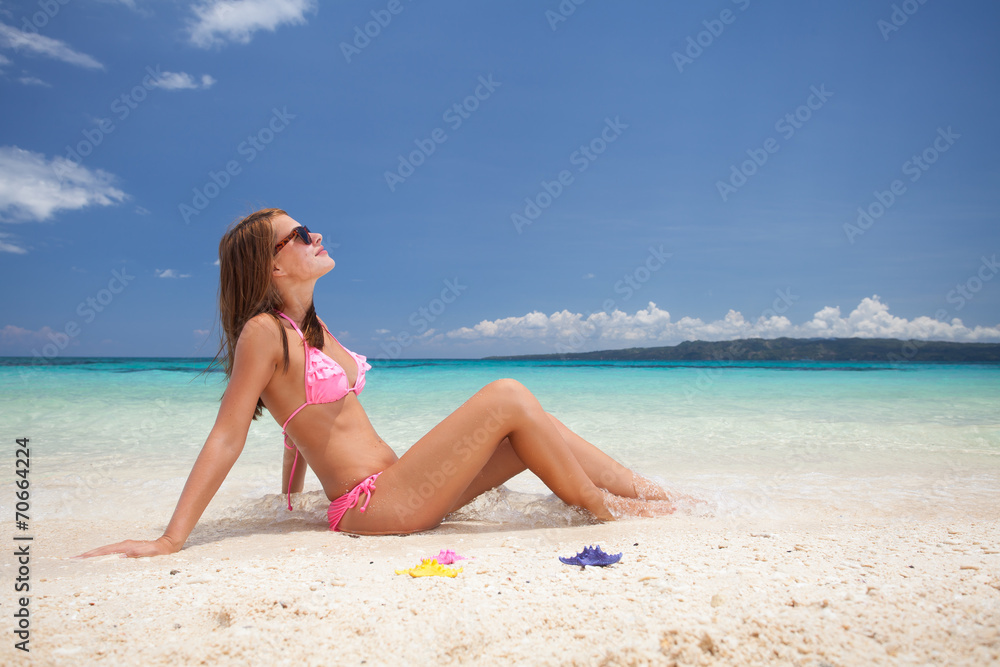 Beautiful girl sitting on the beach