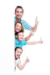 Young family with a banner showing the thumbs-up