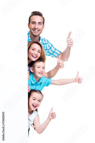 Young family with a banner showing the thumbs-up