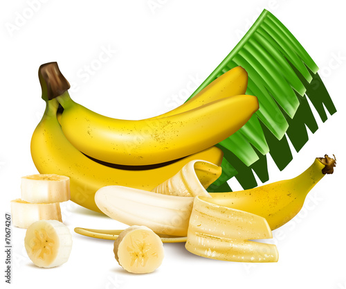 Ripe yellow bananas with slices and leaves.