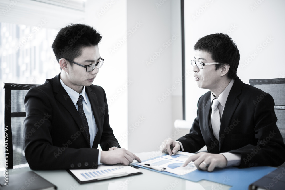 Two Businessmen Having Informal Meeting In Modern Office Two Businessmen Having Informal Meeting In Modern Office