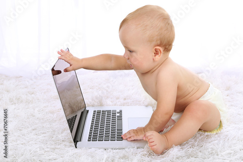 Cute baby boy with laptop o...