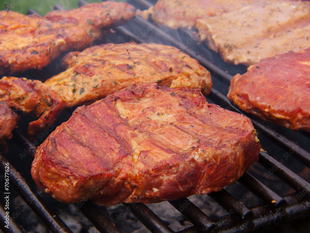 Fresh grilled steak on the grate. 