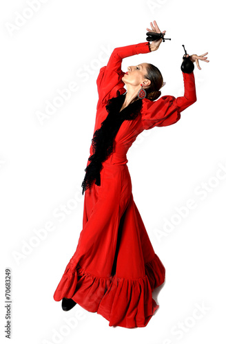 young Spanish woman dancing flamenco with castanets in her hands photo