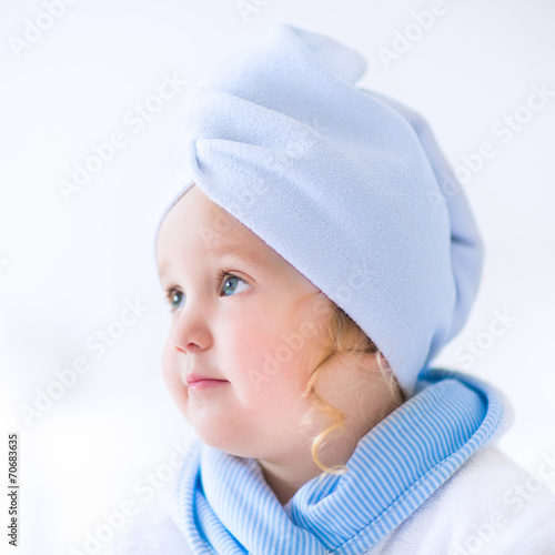 Litlte girl in a bathrobe and towel photo