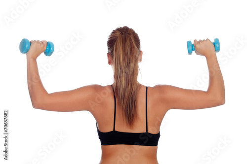 Attractive casual girl training with dumbbells
