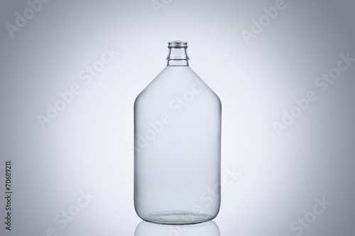Big glass water bottle demijohn isolated on white background photo
