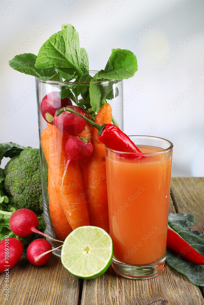 Fresh carrot juice with vegetables on wooden table Fresh carrot juice with vegetables on wooden table