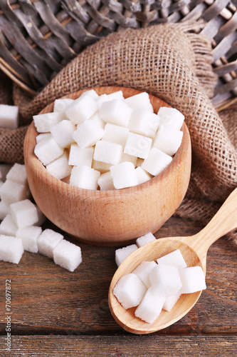Refined sugar wooden bowl on table background