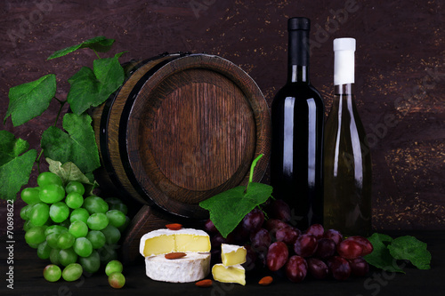 Wine in bottles and in goblet  Camembert and brie cheese 