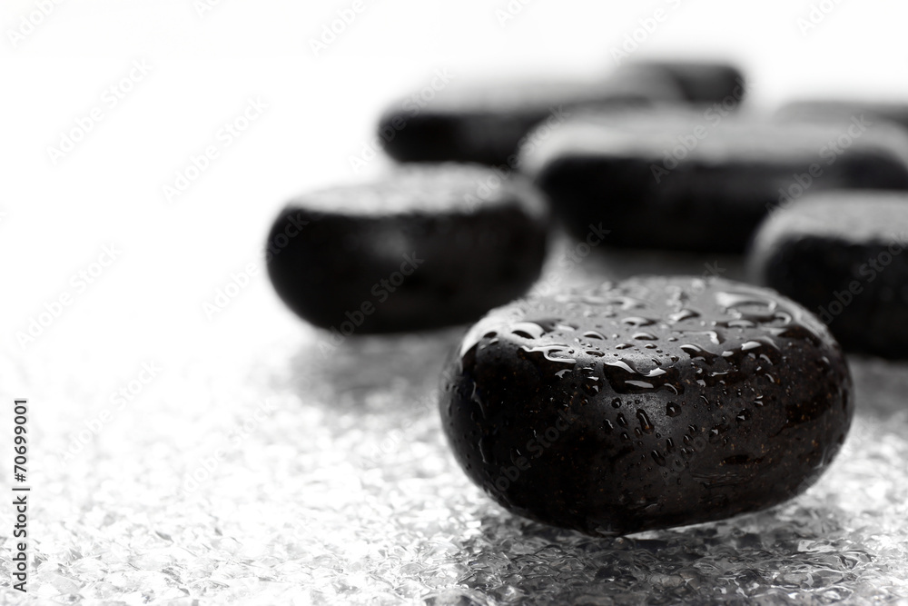 Fototapeta premium Spa stones with drops on light background