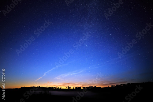 Dawn on a starry background sky and the Milky Way.