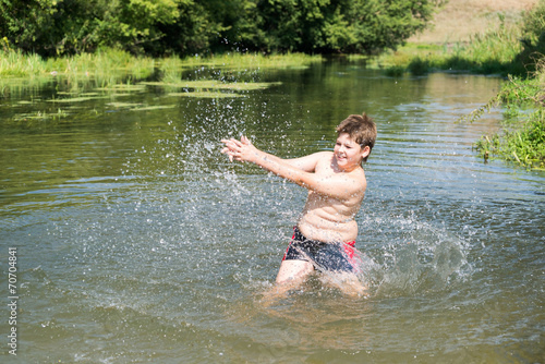 Fototapeta Naklejka Na Ścianę i Meble -  Full 10 years boy swim in  river