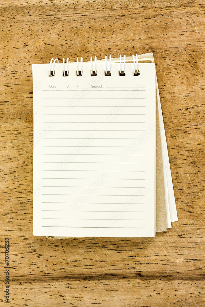 Blank notepad on wooden desk Blank notepad on wooden desk