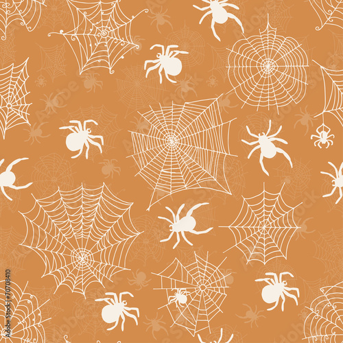 Seamless pattern with white spiders on an orange background