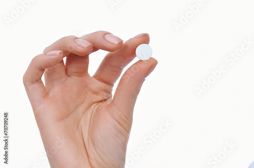 Woman hand with pill