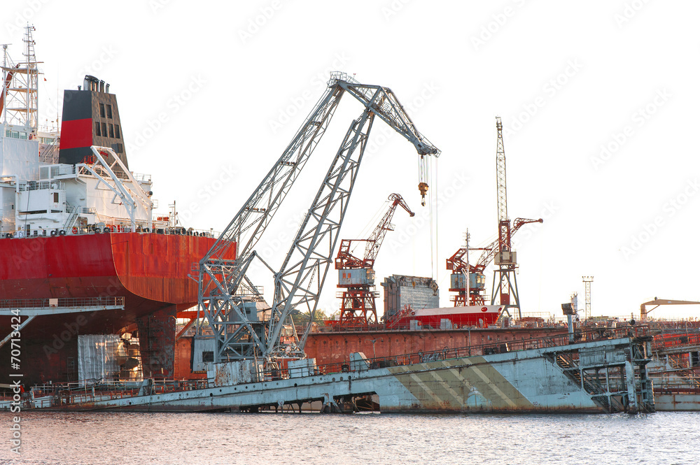 Industrial container cranes and ship at the shipyard docks