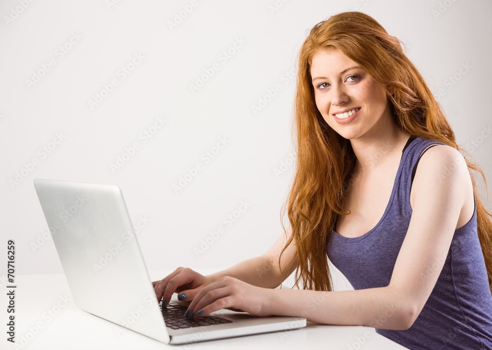 Pretty redhead working on laptop Pretty redhead working on laptop