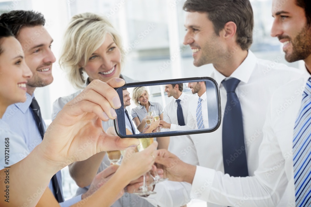 Composite image of hand holding smartphone showing Composite image of hand holding smartphone showing
