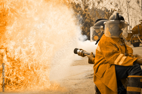 Firemen in action fighting fire during training
