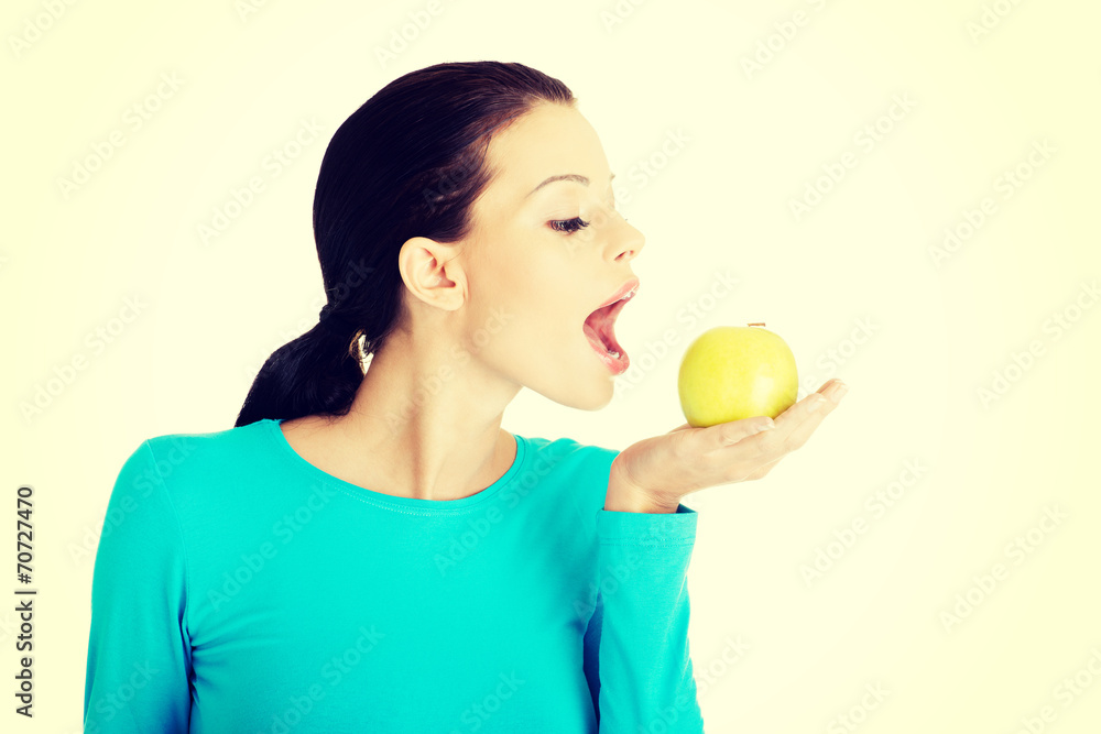 Attractive young woman eating green apple. Attractive young woman eating green apple.