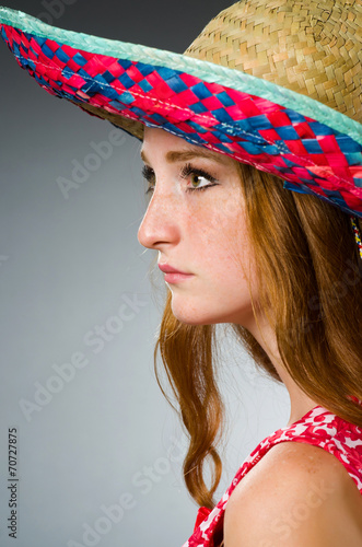 Mexican woman wearing red sombrero