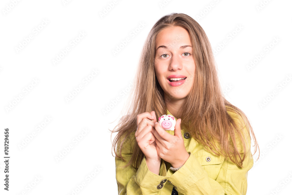 Beautiful young girl putting coin in piggy bank Beautiful young girl putting coin in piggy bank