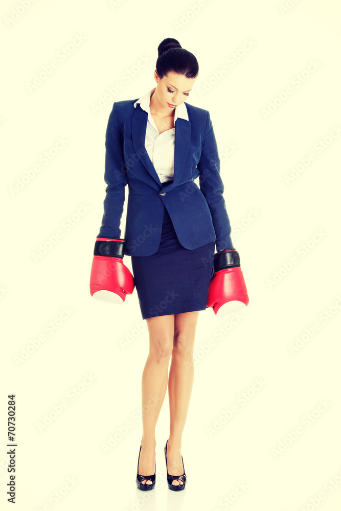 Fototapeta premium Defeated businesswoman in boxing gloves