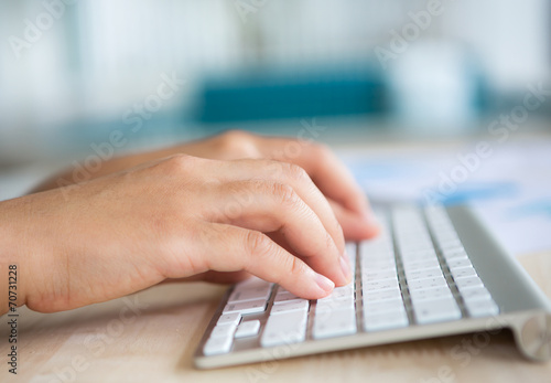 Closeup of business woman hand typing on keyboard