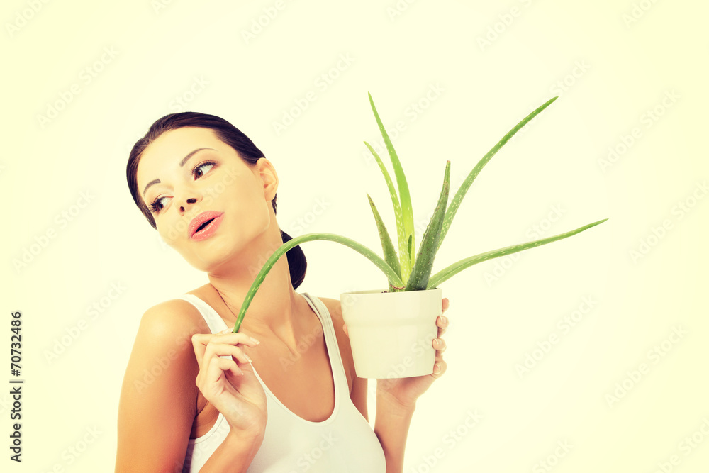 Young beautiful woman's face and aloe vera. Young beautiful woman's face and aloe vera.