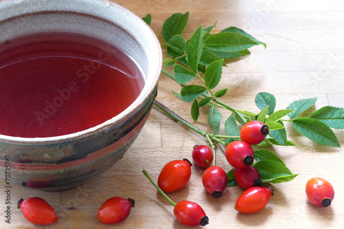 Rose hips and rose hip tea in a ceramic cup