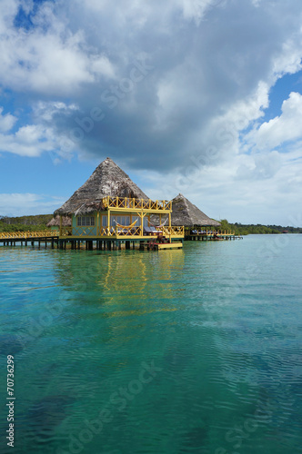 Caribbean resort overwater with thatched roof