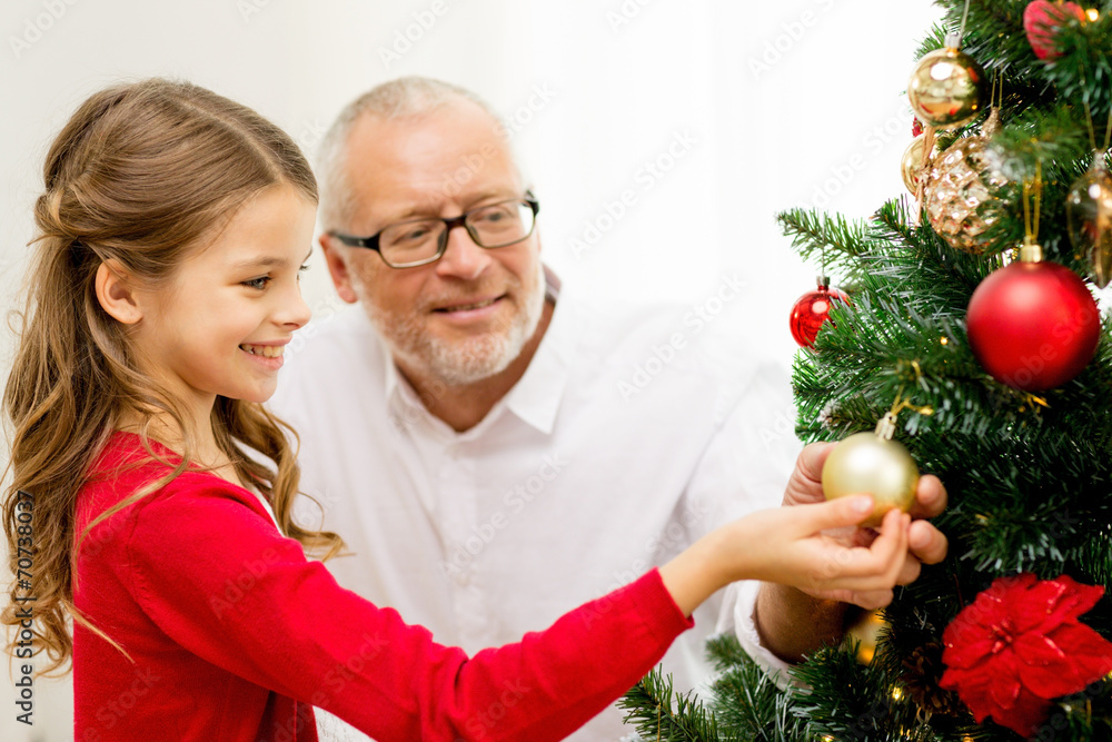 smiling family decorating christmas tree at home smiling family decorating christmas tree at home