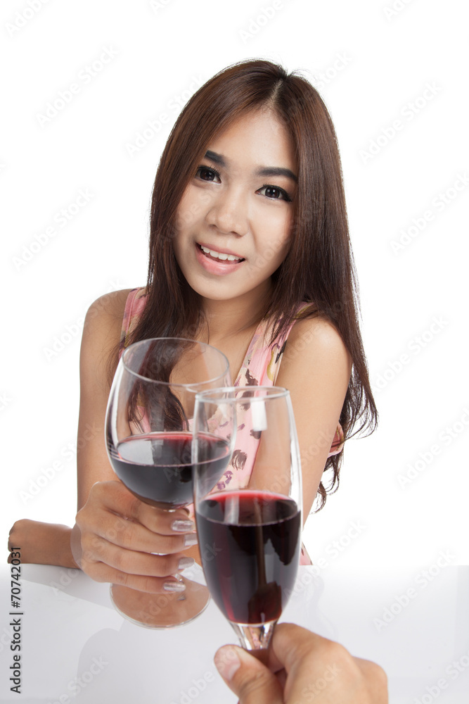 Beautiful Asian woman with red wine cheers to another guy Beautiful Asian woman with red wine cheers to another guy