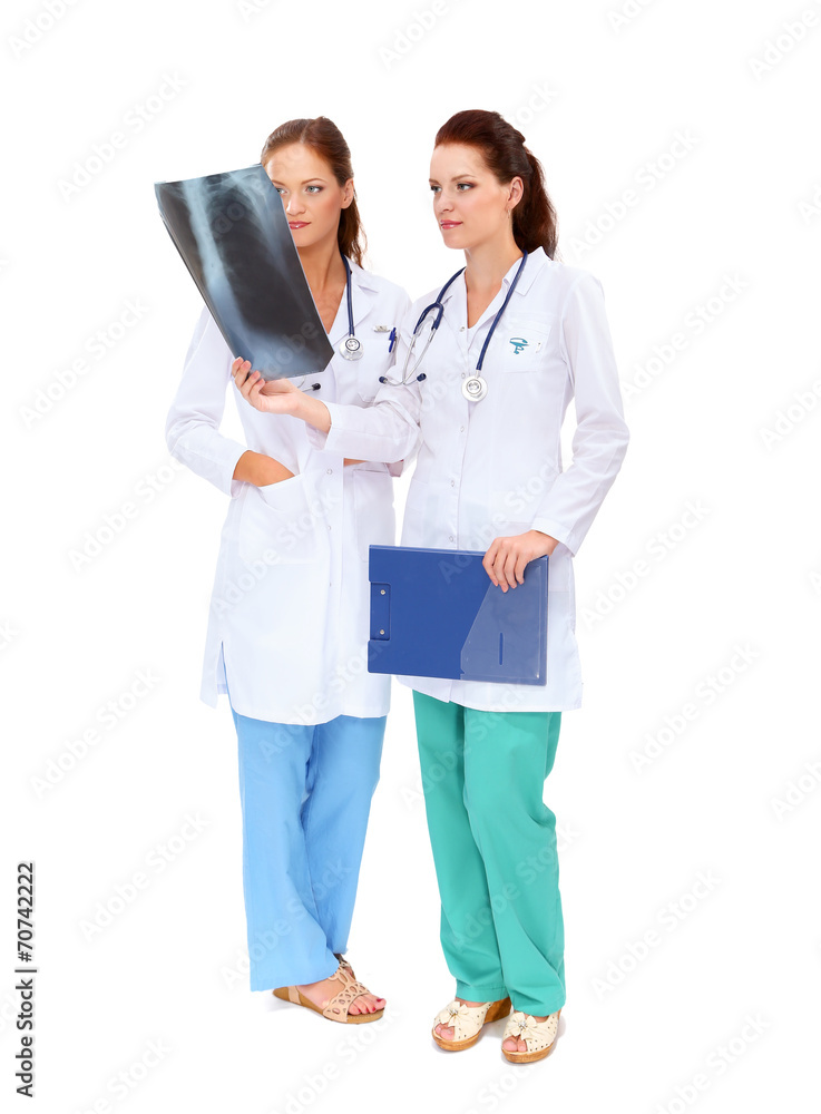Two woman nurse watching X Ray image, standing in hospital Two woman nurse watching X Ray image, standing in hospital