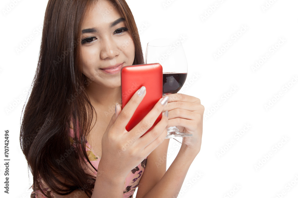 Beautiful Asian woman smile with mobile phone and red wine Beautiful Asian woman smile with mobile phone and red wine