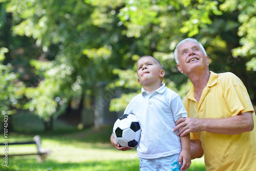 happy grandfather and child in park