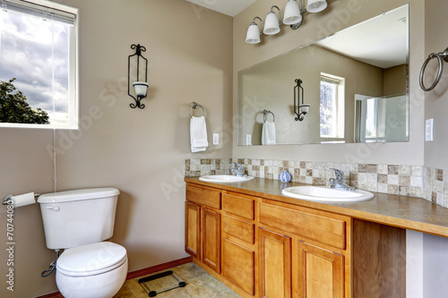 Bathroom cabinet with two sinks and tile trim