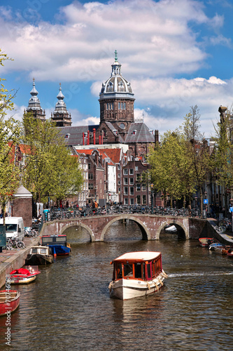 Photography Amsterdam city with boats on canal in Holland