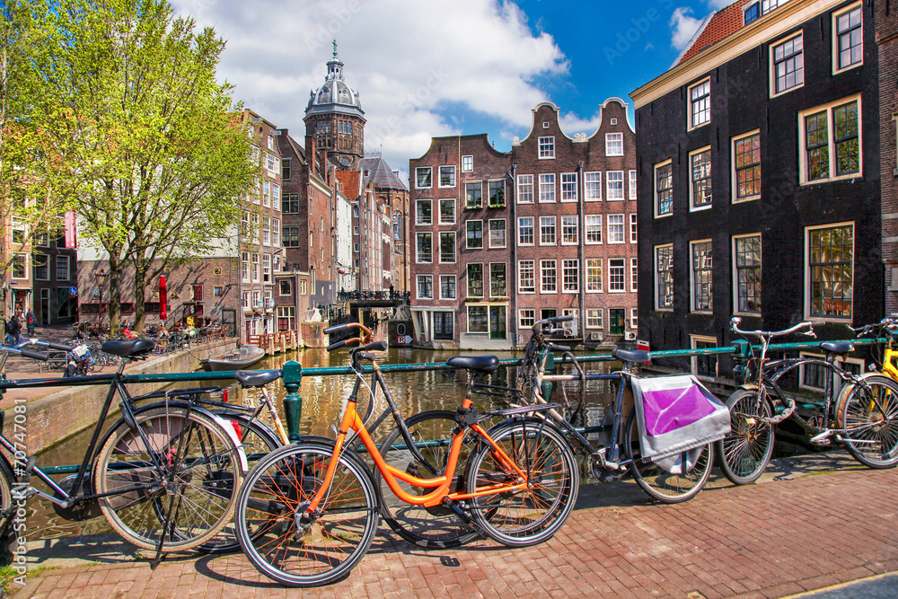 Fototapeta premium Amsterdam city with bikes on the bridge in Holland