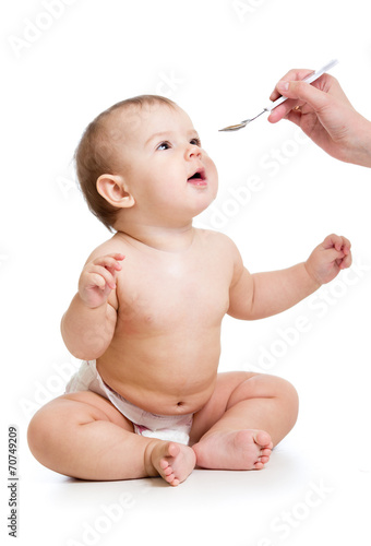 hand feeding baby  with a s...