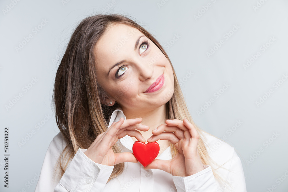 Portrait of a cheerful female holding a heart Portrait of a cheerful female holding a heart