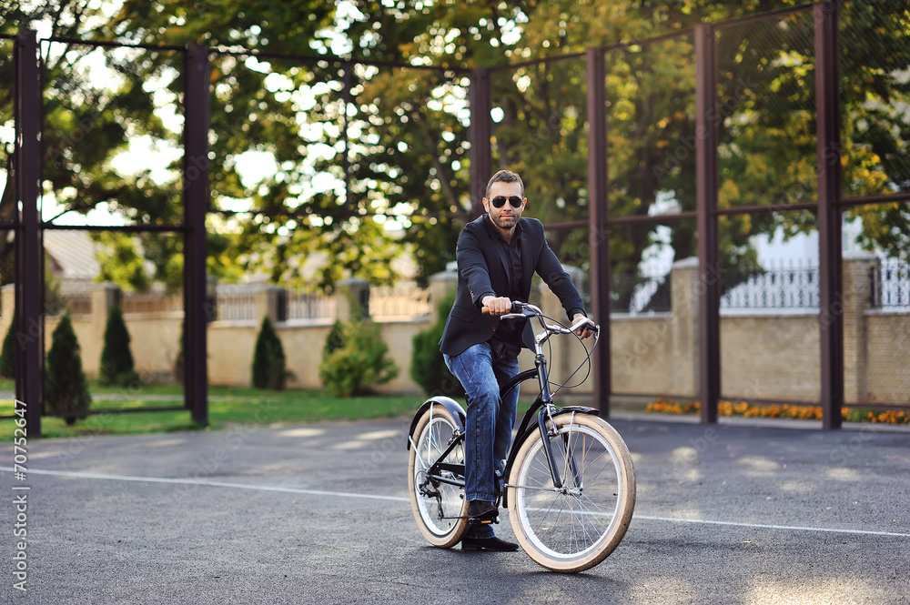 Young stylish man with retro bicycle