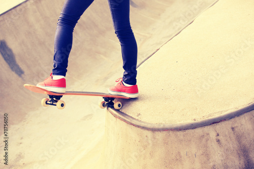 skateboarding woman legs at skatepark 