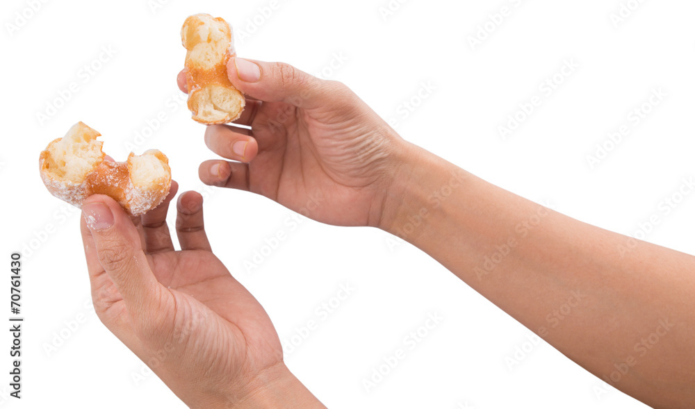 Female hand holding doughnuts over white background Female hand holding doughnuts over white background