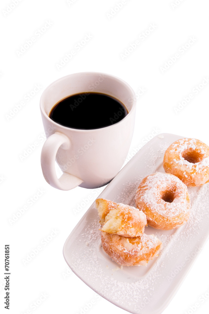 A mug of coffee and homemade doughnut with sugar toppings A mug of coffee and homemade doughnut with sugar toppings