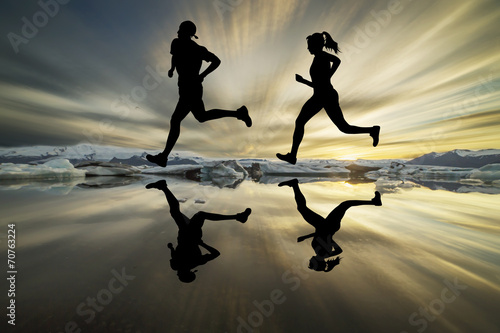Runners silhouette mirrored below with midnight sky as backdrop