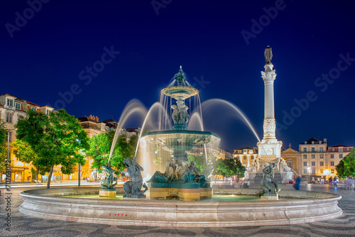 Romantic Lisbon street. Fountain at night in the center